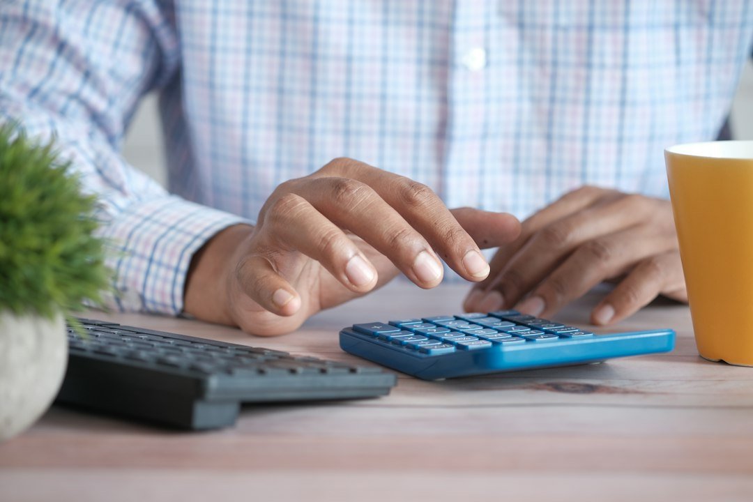 Hand using a calculator to work out GST