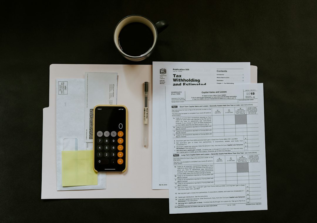 Tax slip, pen and phone on a folder