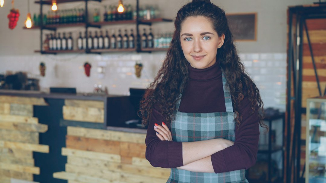 Small business owner standing in her coffee shop