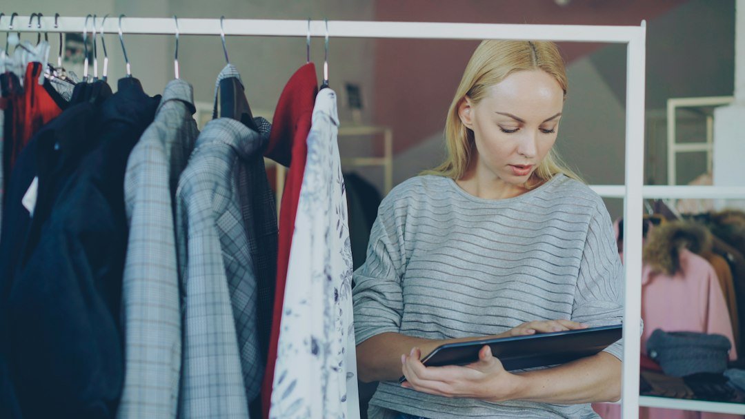 Store owner checking stock with a tablet